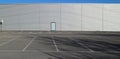 Urban background and copy space. Empty parking in front of an aluminium cladding modern building Royalty Free Stock Photo