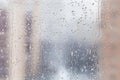 Rain drops on window glass in winter day