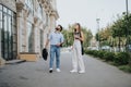 Urban Business Couple Walking and Discussing Growth Strategies Under Autumn Cloudy Day in City Center Royalty Free Stock Photo