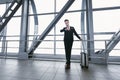 Urban business man standing in airport with suitcase Royalty Free Stock Photo