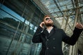 Urban business man in sunglasses talking smart phone traveling walking outside Royalty Free Stock Photo