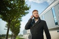 Urban business man talking smart phone traveling walking outside airport Royalty Free Stock Photo