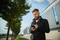 Urban business man talking smart phone traveling walking outside airport Royalty Free Stock Photo