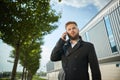 Urban business man talking smart phone traveling walking outside airport Royalty Free Stock Photo