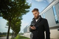 Urban business man talking smart phone traveling walking outside airport Royalty Free Stock Photo