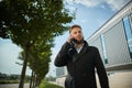 Urban business man talking smart phone traveling walking outside airport Royalty Free Stock Photo
