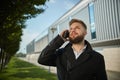 Urban business man talking smart phone traveling walking outside airport Royalty Free Stock Photo