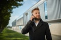 Urban business man talking smart phone traveling walking outside airport Royalty Free Stock Photo