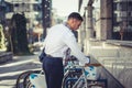 Urban businessman standing next to his bicycle Royalty Free Stock Photo