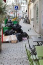 urban cafe set next to garbage and waste bursting over Royalty Free Stock Photo