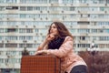 Urban city lifestyle cityscape and young woman with vintage suitcase thinking about life Royalty Free Stock Photo