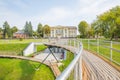 Urban city and peoples. Iron bridge on the lake. Green nature an