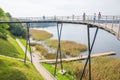 Urban city and peoples. Iron bridge on the lake. Green nature an