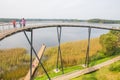 Urban city and peoples. Iron bridge on the lake. Green nature an