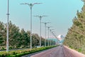 Urban city scape of Ashgabat city center with wide highway and light traffic. Ashgabat International Airport in background.