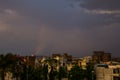 Urban city scape on rainy day with beautiful clouds and a thin rainbow Royalty Free Stock Photo