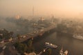 Urban cityscape with a bridge across the river and boats Royalty Free Stock Photo