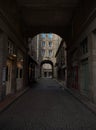 Urban cityscape view of stone gate arch architecture in empty narrow cobblestone street of Saint Malo Brittany France