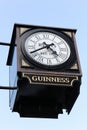 Urban clock with Guinness beer sign Royalty Free Stock Photo