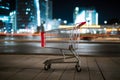 Urban commerce ambiance shopping cart against blurred night cityscape backdrop