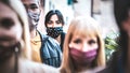 Urban commuter crowd of people moving on city street covered by face mask - New normal human condition and society concept