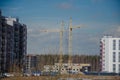 Urban construction of buildings, cranes on the background of the sky