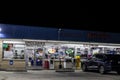 Urban convenience store at night parked cars open late
