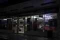Urban convenience store at night side view entrance