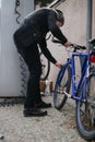 Urban cyclist checking bicycle tire before riding in the city Royalty Free Stock Photo