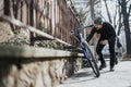 Urban cyclist taking a break to check his smart phone on a sunny day Royalty Free Stock Photo