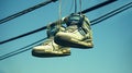 Urban Expression, Sneakers Hanging on a Telephone Wire Against the Blue Sky, Generative AI