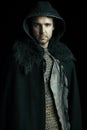 An urban fantasy or high fantasy man wearing a mail shirt, leather jerkin and cloak