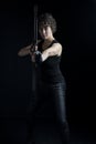 An urban fantasy woman wearing all black and firing a bow and arrow Royalty Free Stock Photo