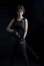 An urban fantasy woman wearing all black and holding a bow and arrow
