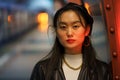 Urban fashion portrait of chinese woman wear leather beret and jacket, earrings at subway platform Royalty Free Stock Photo