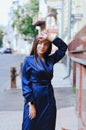 Urban fashion portrait of a stylish young business woman in a long blue dress and with long hair. Royalty Free Stock Photo