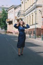 Urban fashion portrait of a stylish young business woman in a long blue dress and with long hair. Royalty Free Stock Photo