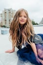 Urban fashion portrait of a teenage girl in the street at the railing on the stairs. Royalty Free Stock Photo