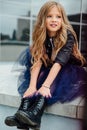 Urban fashion portrait of a teenage girl in the street at the railing on the stairs. Royalty Free Stock Photo