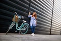 Urban female taking selfie in city near bike