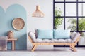 Urban jungle in bright white and blue living room interior with scandinavian futon sofa Royalty Free Stock Photo