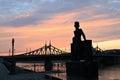 Urban landscape and a beautiful sunset in the evening on the river embankment with a bridge. Russia, Tver, monument to Pushkin A.