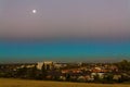 Australian urban landscape at blue hour by full moon in hazy sky Royalty Free Stock Photo