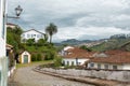 Urban landscape with cobbled street, colonial houses and mountain in the background in Ouro Preto, Brazil