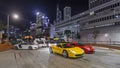 The urban landscape of Hong Kong with sportcars at night and through the city traffic timelapse hyperlapse