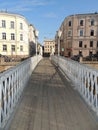 Urban landscape pedestrian bridge from river building and cars