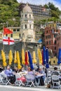 Urban landscape, port town, outdoor restaurant, colorful sun umbrellas, Vernazza, Cinque Terre, Italy