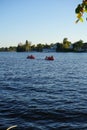 Two red catamarans sail along the Dahme River near Schlossinsel Island. 12557 Berlin, Germany