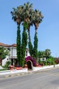 Urban landscape in the village of Chamyuva. City view of the roadside hotel palma rosa with tall palm trees. Travel the
