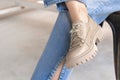 Urban lifestyle clothes, close-up to the fashion sneakers and denim jeans on teen girl. Street fashion concept photo Royalty Free Stock Photo